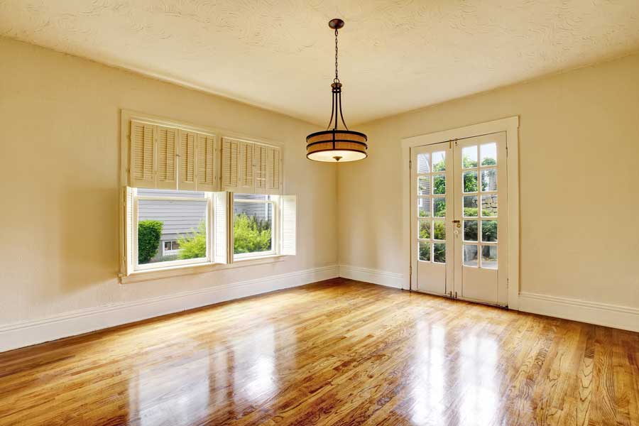 Dining room with hardwood floors and a chandelier hanging from the ceiling