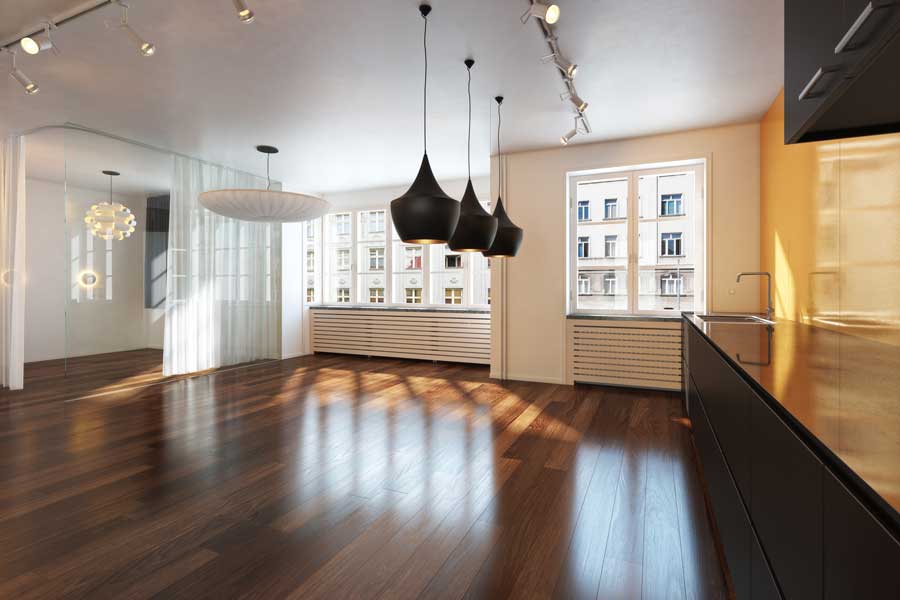 Kitchen with a wooden floor and black cabinets, a sink with a tap, a countertop, a glass door, curtains