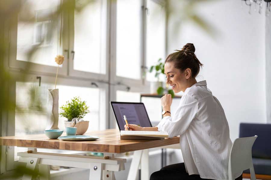 Woman sitting at a desk with a laptop computer in front of her