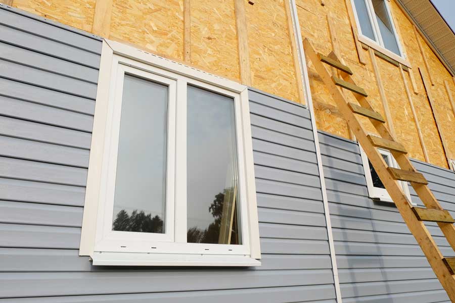 House under construction with a ladder leaning against the side of it