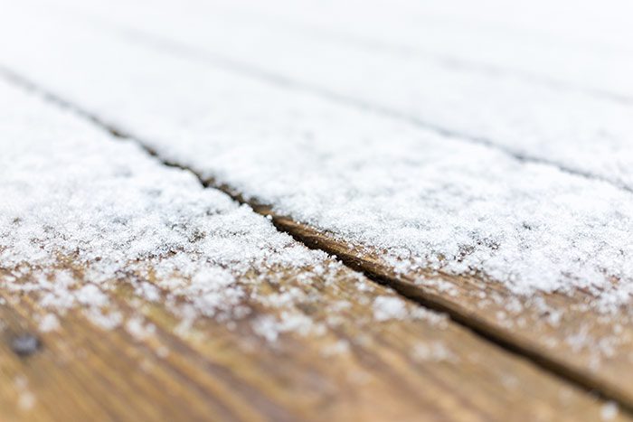 Wooden deck covered in snow, with a white background
