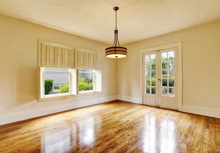 Dining room with hardwood floors and a chandelier hanging from the ceiling