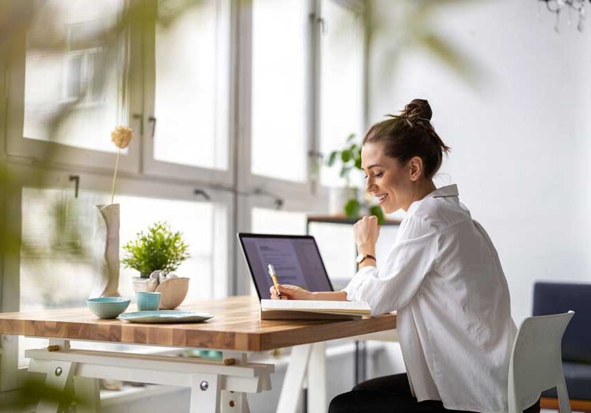 Woman sitting at a desk with a laptop computer in front of her