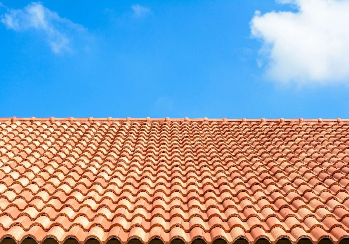 Red tiled roof with a blue sky in the background, providing a vivid contrast between the two colors