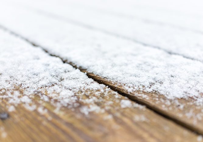 Wooden deck covered in snow, with a white background